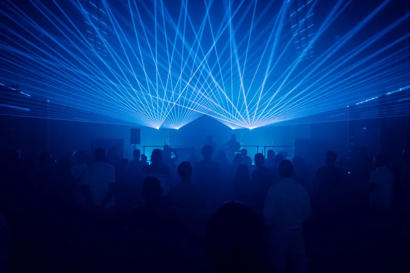 The warehouse room at Eutopia Warehouse, packed floor under blue lasers